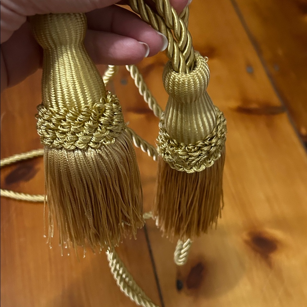 Pair of gold curtain tiebacks